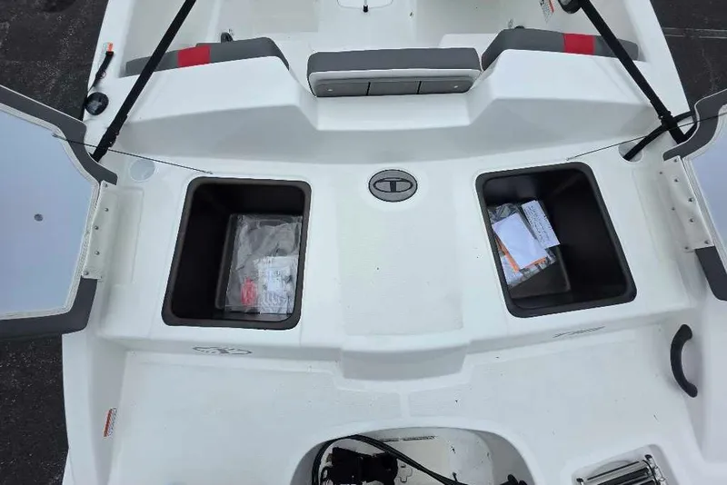 Slide: The Image of 2027 Tahoe T18 boat storage compartments with open lids, showcasing interior space. - 9