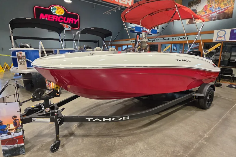 Slide: The Image of 2027 Tahoe T18 boat with red hull and canopy on display in showroom. - 2