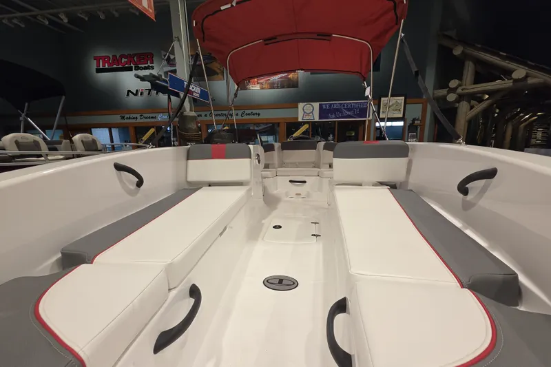 Slide: The Image of Interior view of 2027 Tahoe T18 boat with red canopy and seating. - 4