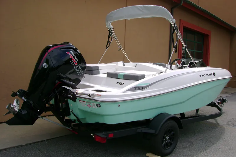 Slide: The Image of 2027 Tahoe T18 boat with Mercury Pro XS engine on trailer, parked outdoors. - 4