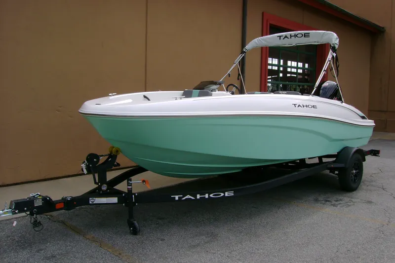 Slide: The Image of 2027 Tahoe T18 boat on trailer, mint green hull, parked outdoors. - 3