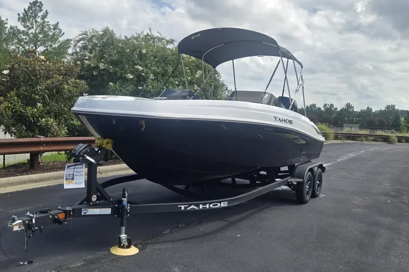 Slide: The Image of 2027 Tahoe T21 boat on trailer, parked outdoors under cloudy sky. - 3