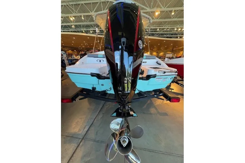Slide: The Image of 2027 Tahoe T18 boat with a powerful outboard motor, displayed indoors. - 4