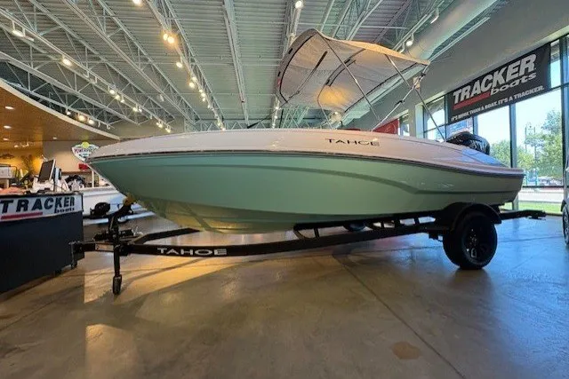 Slide: The Image of 2027 Tahoe T18 boat displayed indoors on a trailer, under showroom lighting. - 1