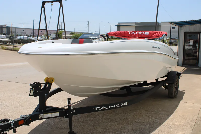 Slide: The Image of 2027 Tahoe T18 boat on trailer, parked outdoors, featuring sleek white design. - 3