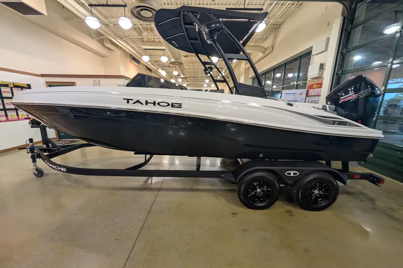 The Image of 2027 Tahoe T21 boat on display indoors, featuring sleek design and modern trailer. - 0