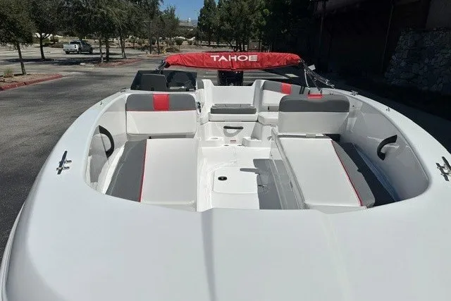 Slide: The Image of 2027 Tahoe T18 boat with white and red interior, parked outdoors. - 8