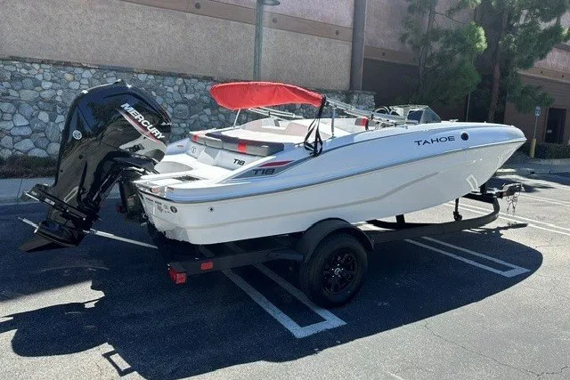 Slide: The Image of 2027 Tahoe T18 boat on trailer with Mercury outboard motor in parking lot. - 4