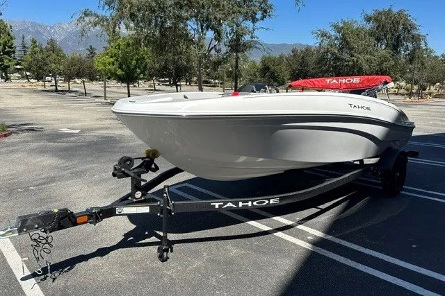 Slide: The Image of 2027 Tahoe T18 boat on trailer in sunny parking lot. - 2