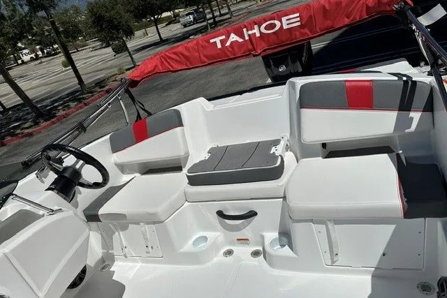 Slide: The Image of 2027 Tahoe T18 boat interior with white and gray seating, red accents, and steering wheel. - 10