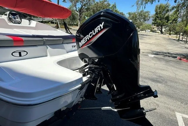 Slide: The Image of 2027 Tahoe T18 boat with Mercury outboard motor in a parking lot. - 7