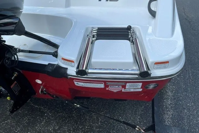 Slide: The Image of 2027 Tahoe T16 boat rear view with ladder and red hull detailing. - 8