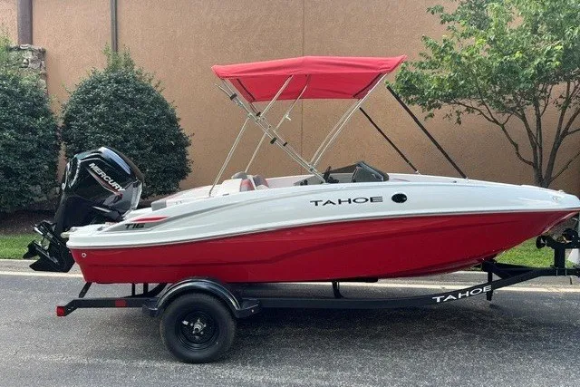 The Image of 2027 Tahoe T16 boat with red canopy and trailer, parked outdoors. - 0