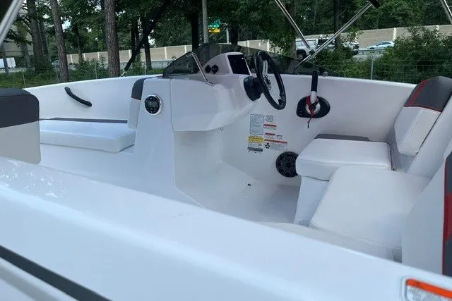 Slide: The Image of 2027 Tahoe T16 boat interior with white seating and steering wheel. - 7