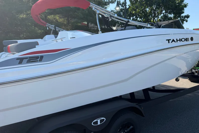 Slide: The Image of 2027 Tahoe T21 boat with sleek white design and red accents on trailer. - 8