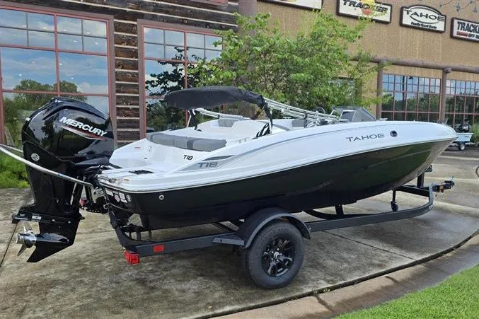 Slide: The Image of 2027 Tahoe T18 boat with Mercury engine on trailer, parked outdoors. - 3
