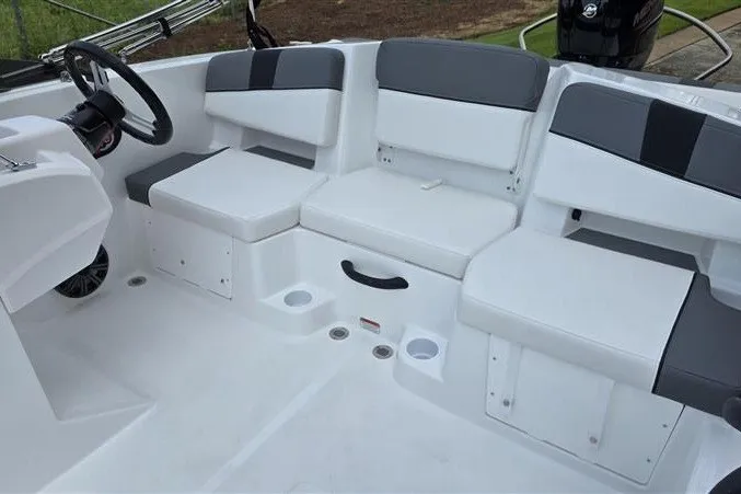 Slide: The Image of 2027 Tahoe T18 boat interior with gray and white seating, steering wheel, and cup holders. - 10