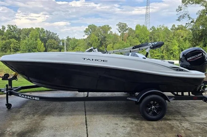 The Image of 2027 Tahoe T18 boat on trailer, featuring sleek design and Mercury outboard motor. - 0