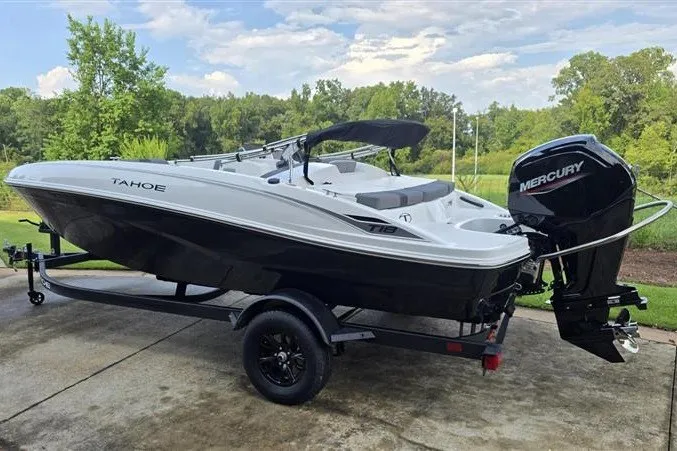 Slide: The Image of 2027 Tahoe T18 boat with Mercury engine on trailer, parked outdoors. - 1