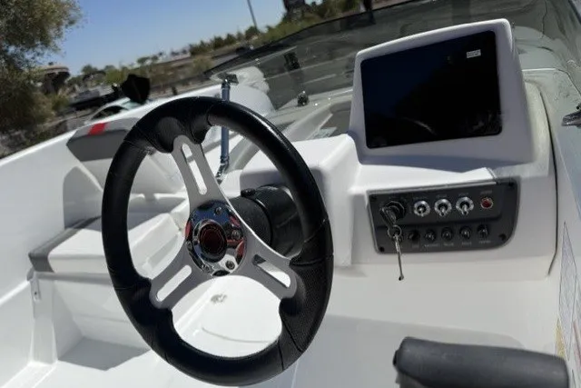 Slide: The Image of Steering wheel and dashboard of 2027 Tahoe T16 boat, featuring modern controls and display. - 5