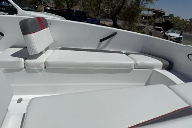 Slide: The Image of 2027 Tahoe T16 boat interior with white cushioned seating and red accents. - 7