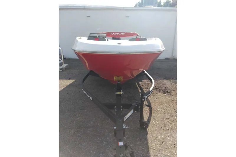 Slide: The Image of 2027 Tahoe T18 boat on trailer, red and white design, parked outdoors. - 1
