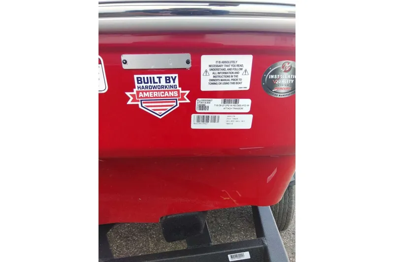 Slide: The Image of Red Tahoe T18 boat with stickers emphasizing American craftsmanship and towing instructions. - 7