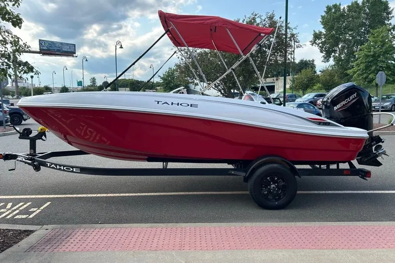 Slide: The Image of 2027 Tahoe T18 boat with red hull and Mercury engine on trailer. - 1