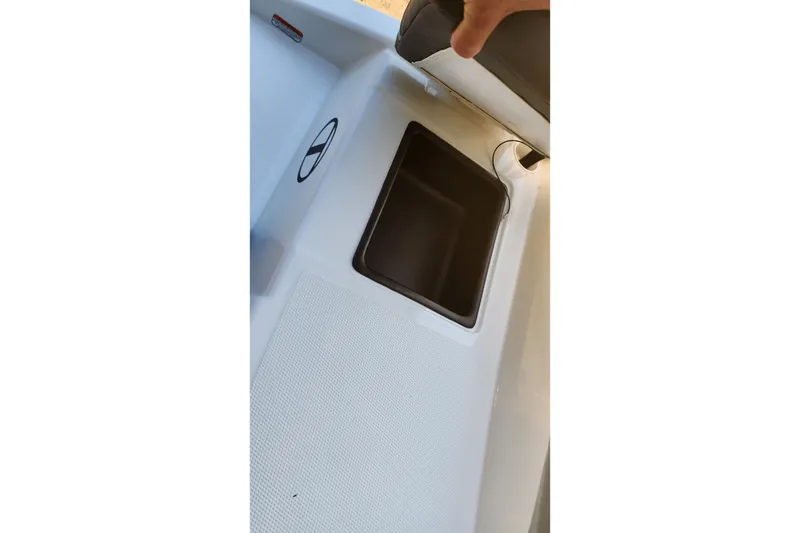 Slide: The Image of 2027 Tahoe T16 boat storage compartment with open lid, showcasing interior space. - 67