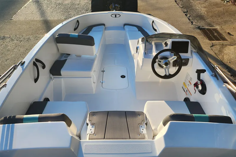 Slide: The Image of 2027 Tahoe T16 boat interior with modern seating and steering console. - 3
