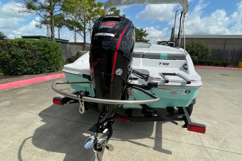 Slide: The Image of 2027 Tahoe T18 boat with Mercury 115 outboard motor, parked outdoors. - 5