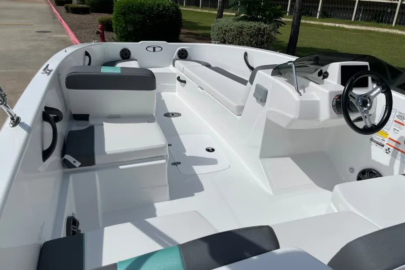 Slide: The Image of 2027 Tahoe T18 boat interior with seating, steering wheel, and modern design. - 10