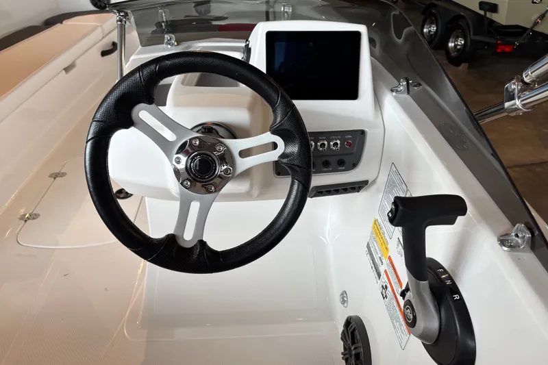 Slide: The Image of Steering console of a 2027 Tahoe T18 boat with modern controls and display. - 1