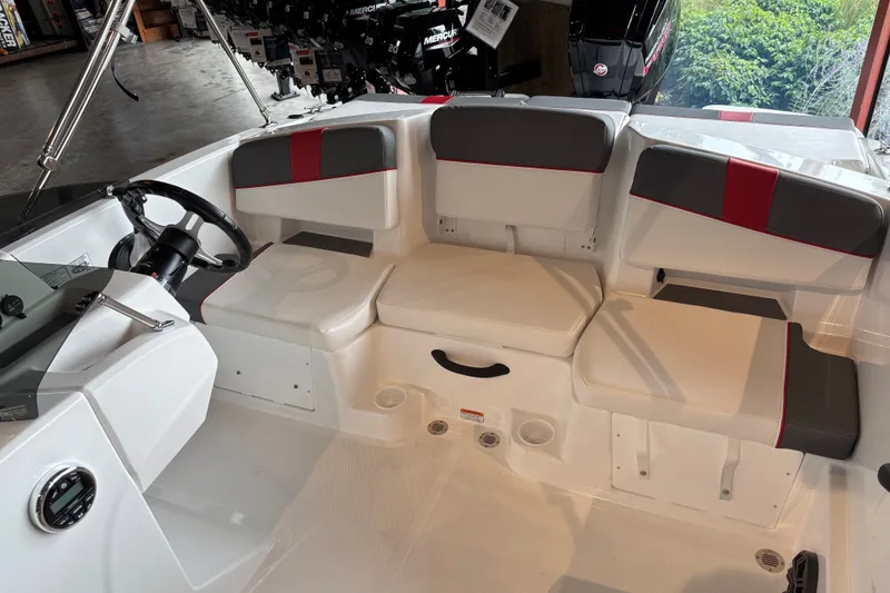 Slide: The Image of 2027 Tahoe T18 boat interior with modern seating and steering wheel in showroom. - 3