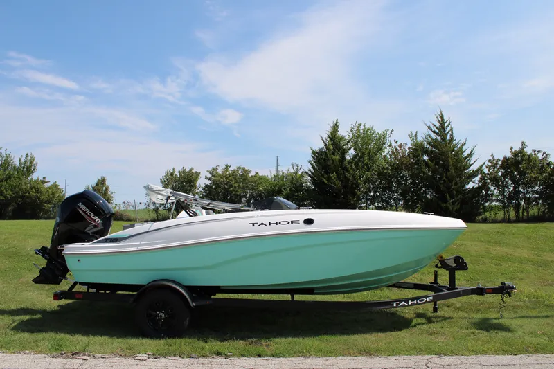 The Image of 2027 Tahoe T18 boat on trailer, parked on grass under a clear blue sky. - 0