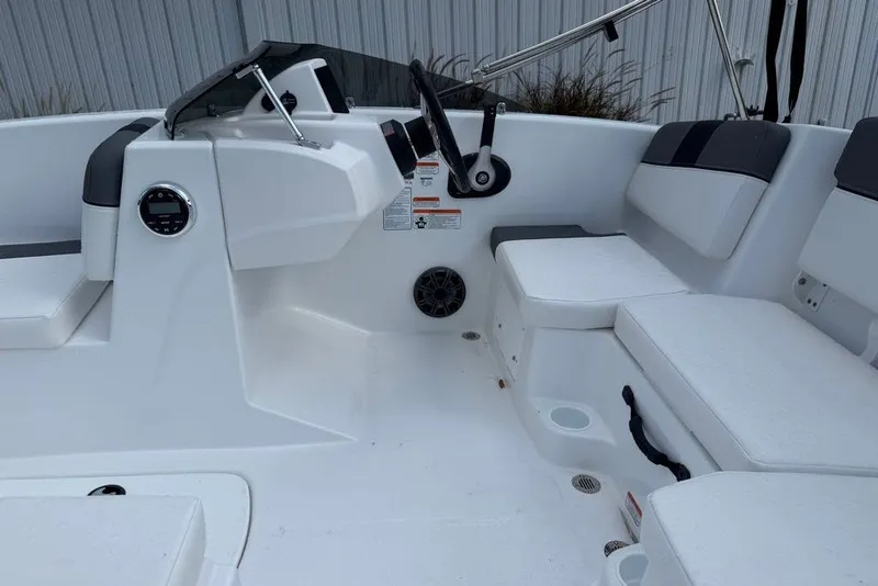 Slide: The Image of 2027 Tahoe T16 boat interior with white seating and steering console. - 68