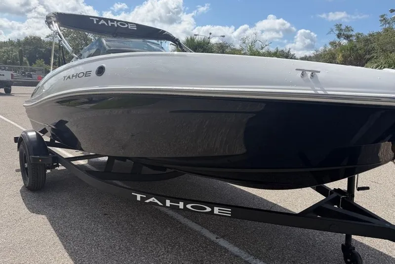 Slide: The Image of 2027 Tahoe T16 boat on trailer, sleek design, parked outdoors under a blue sky. - 3