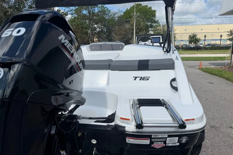 Slide: The Image of 2027 Tahoe T16 boat with Mercury 60 engine, parked outdoors. - 65