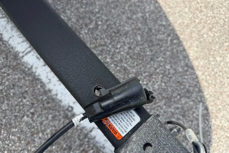 Slide: The Image of Close-up of a 2027 Tahoe T16 trailer hitch with warning label and wiring. - 67
