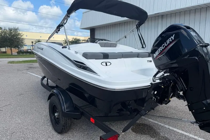 Slide: The Image of 2027 Tahoe T16 boat with Mercury engine on trailer, parked outdoors. - 4