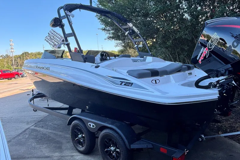 Slide: The Image of 2027 Tahoe T21 boat on trailer, sleek design, black and white color scheme. - 1