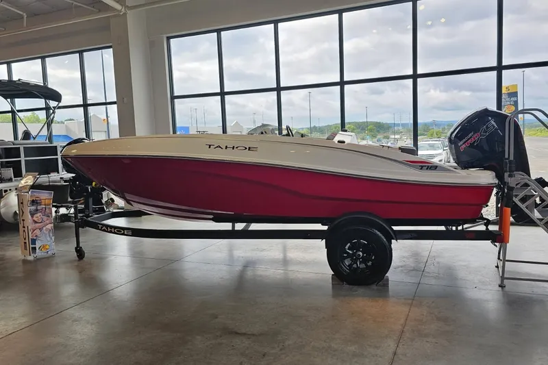 Slide: The Image of 2027 Tahoe T18 boat with red hull on display in showroom. - 1