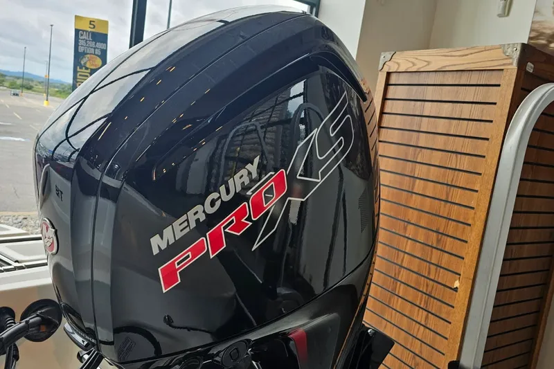 Slide: The Image of Mercury Pro XS engine on a 2027 Tahoe T18 boat, displayed indoors. - 2