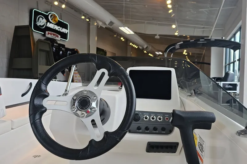 Slide: The Image of Steering wheel and dashboard of 2027 Tahoe T18 boat in showroom. - 3