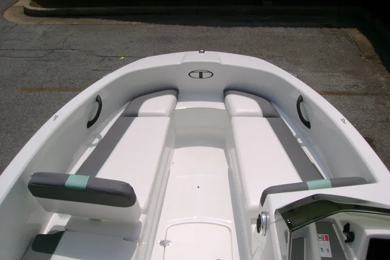 Slide: The Image of 2027 Tahoe T16 boat interior with white and gray seating, sleek design. - 9