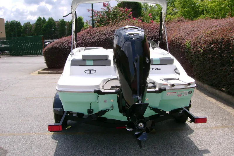 Slide: The Image of 2027 Tahoe T16 boat with outboard motor on trailer, parked outdoors. - 7