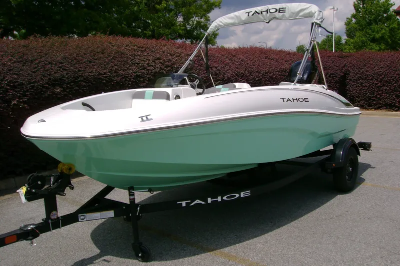 Slide: The Image of 2027 Tahoe T16 boat on trailer, white and mint green design, parked outdoors. - 3