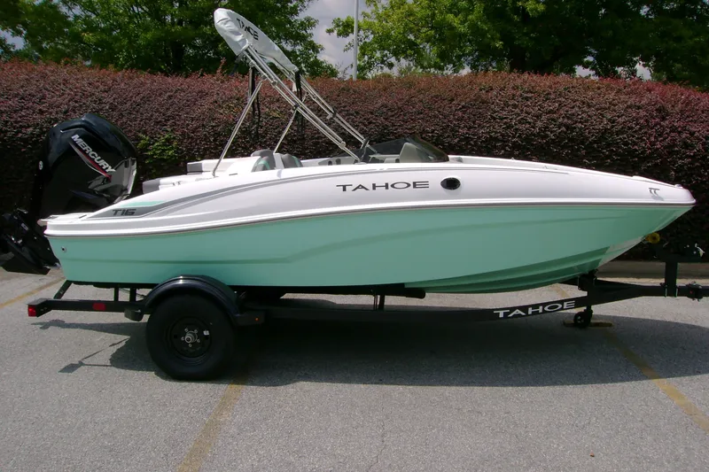 Slide: The Image of 2027 Tahoe T16 boat on trailer, mint green hull, parked outdoors. - 1