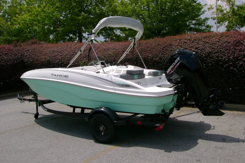 Slide: The Image of 2027 Tahoe T16 boat on trailer with Mercury outboard motor, parked outdoors. - 5