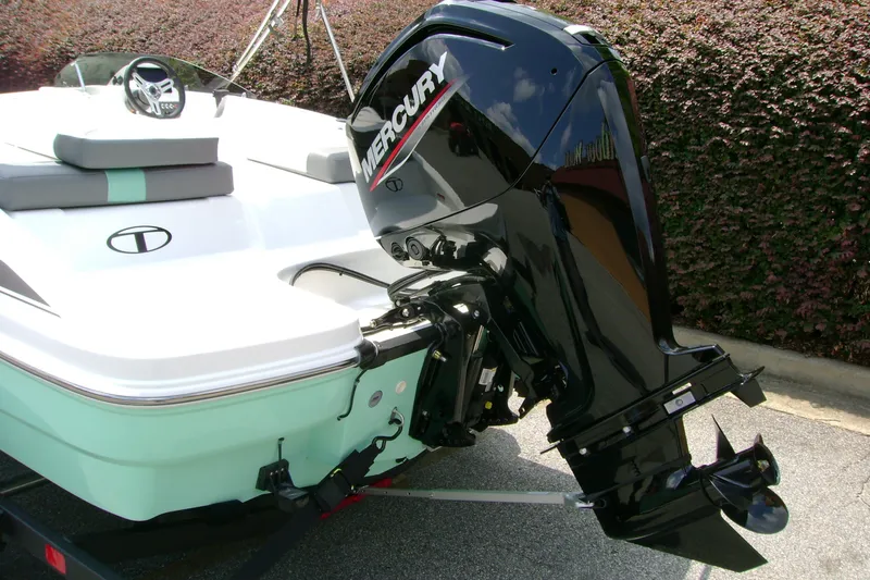 Slide: The Image of 2027 Tahoe T16 boat with Mercury outboard motor, parked on a trailer. - 8